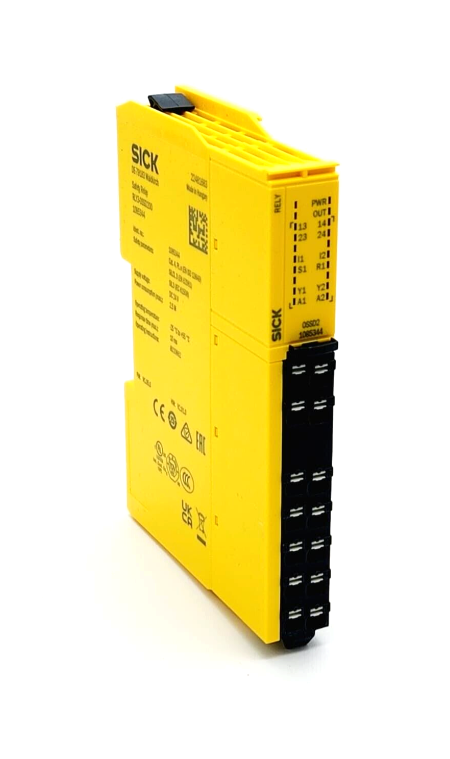 Yellow SICK safety relay module for industrial automation with various input and output terminals, featuring compliance markings.