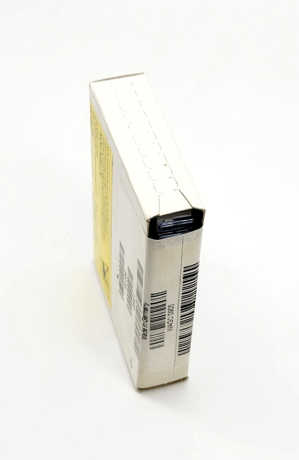 Compact white packaging box with product barcodes and labels on a light background.