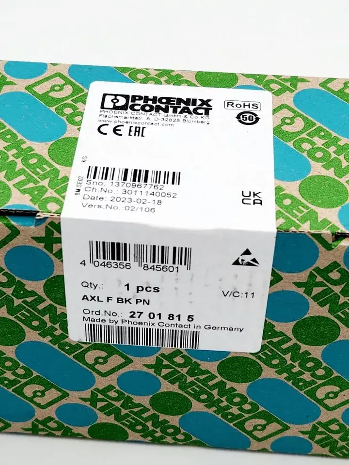 Phoenix Contact AXL F BK PN Buskoppler packaging with label showing part number 2701815 and QR code.