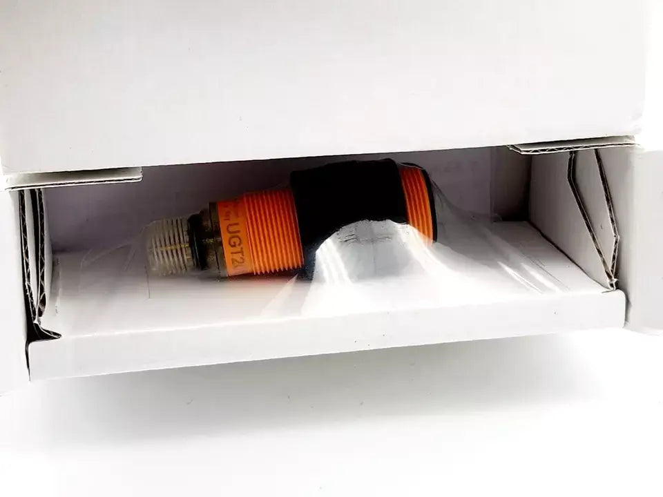 ifm UGT201 ultrasonic sensor in original packaging, orange and black, model UGC00800EOKG/US PNP with M18 x 1 thread.