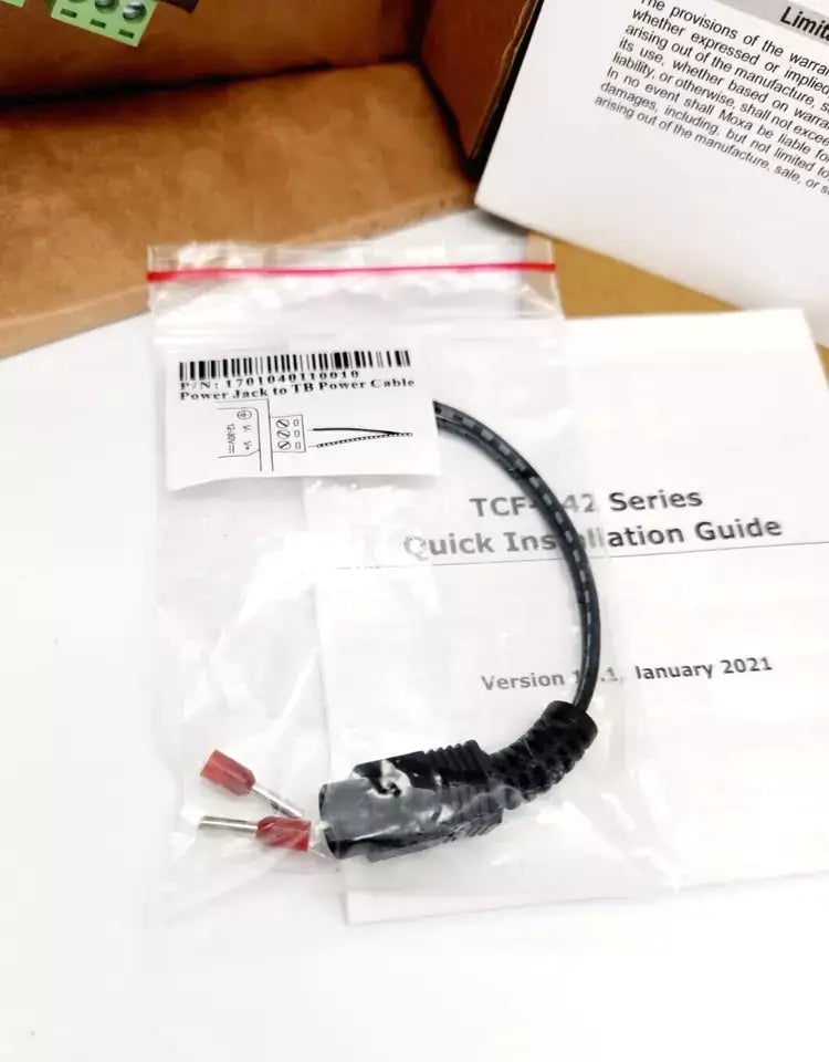 Moxa TCF-142 series installation guide and cable shown on table.