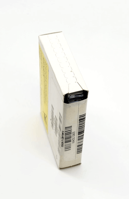 Compact white packaging box with product barcodes and labels on a light background.
