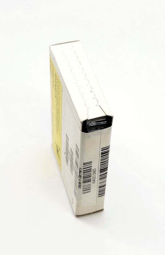 Compact white packaging box with product barcodes and labels on a light background.