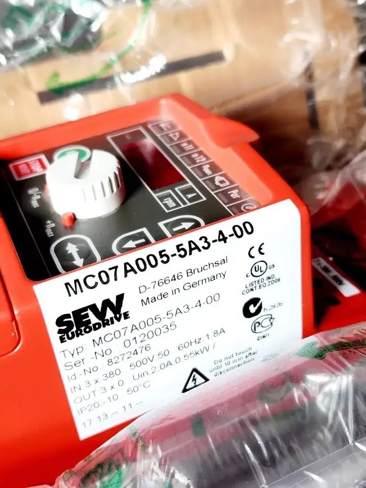SEW Eurodrive MC07A005-5A3-4-00 frequency inverter with product label, model 8272476, showing control dials and branding.