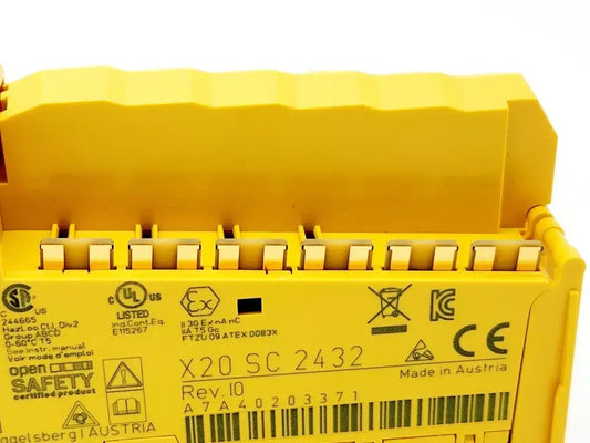 B&R X20SC2432 safety module with digital inputs and pulse outputs, close-up of labels and connectors, yellow casing.