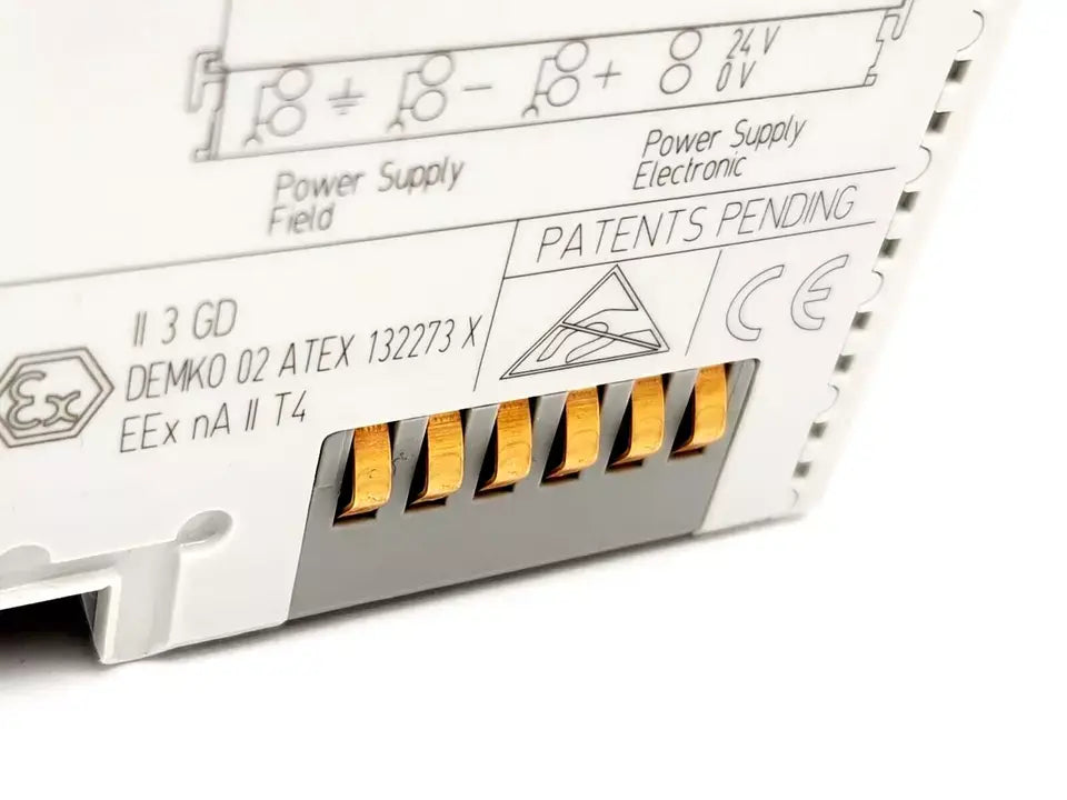 Close-up of electronic component with patents pending markings and power connections.