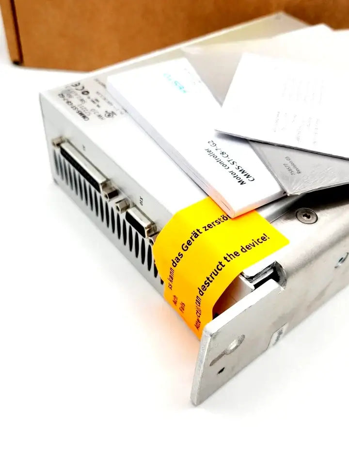 Festo 572211 Motorcontroller CMMS-ST-C8-7-G2 with manuals and packaging, featuring connectivity ports and a caution label.